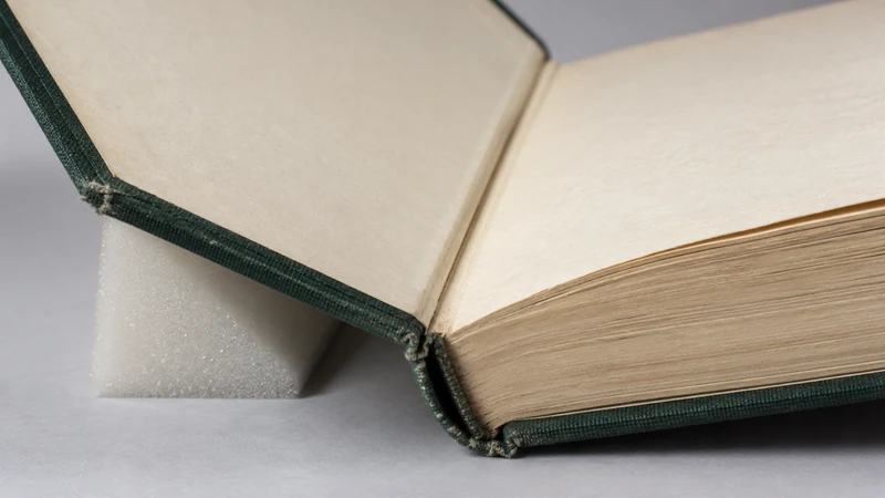 Close view of a hardback's inner hinge, with its cover on a foam support.