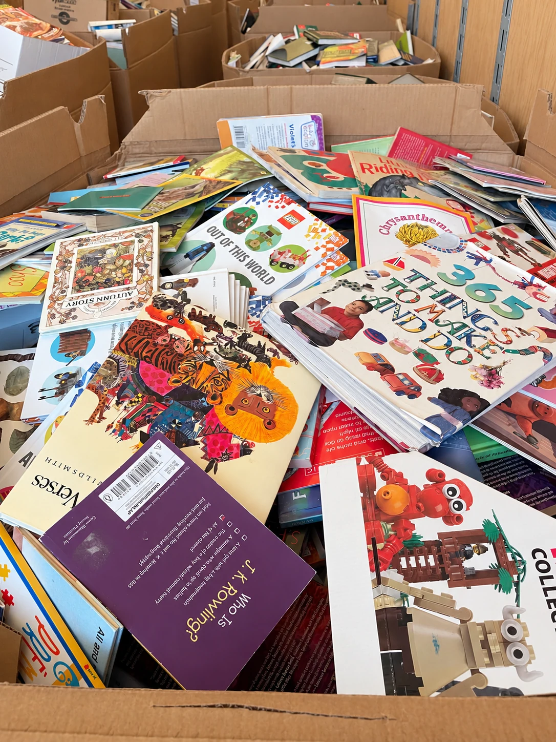 Mixed used books in a large cardboard box at the Concord warehouse.